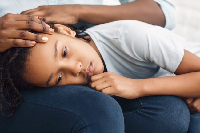 Close-up Of Girl's Head On Lap, African Mother Comforting Her Sad Child On Sofa At Home, Panorama