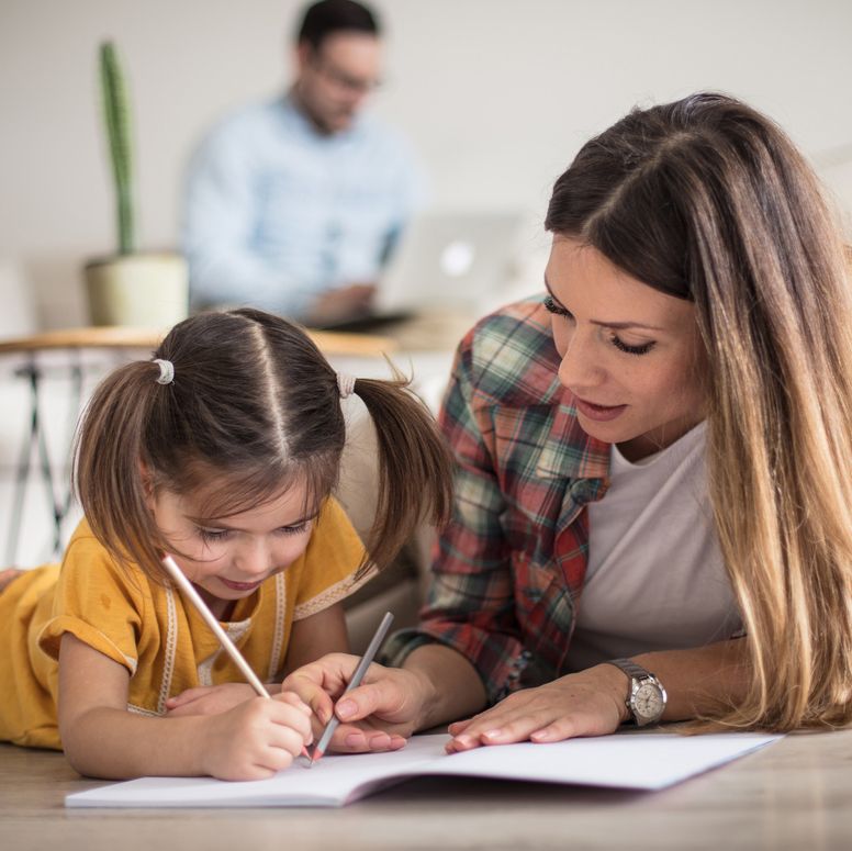 Adult and child doing homework together