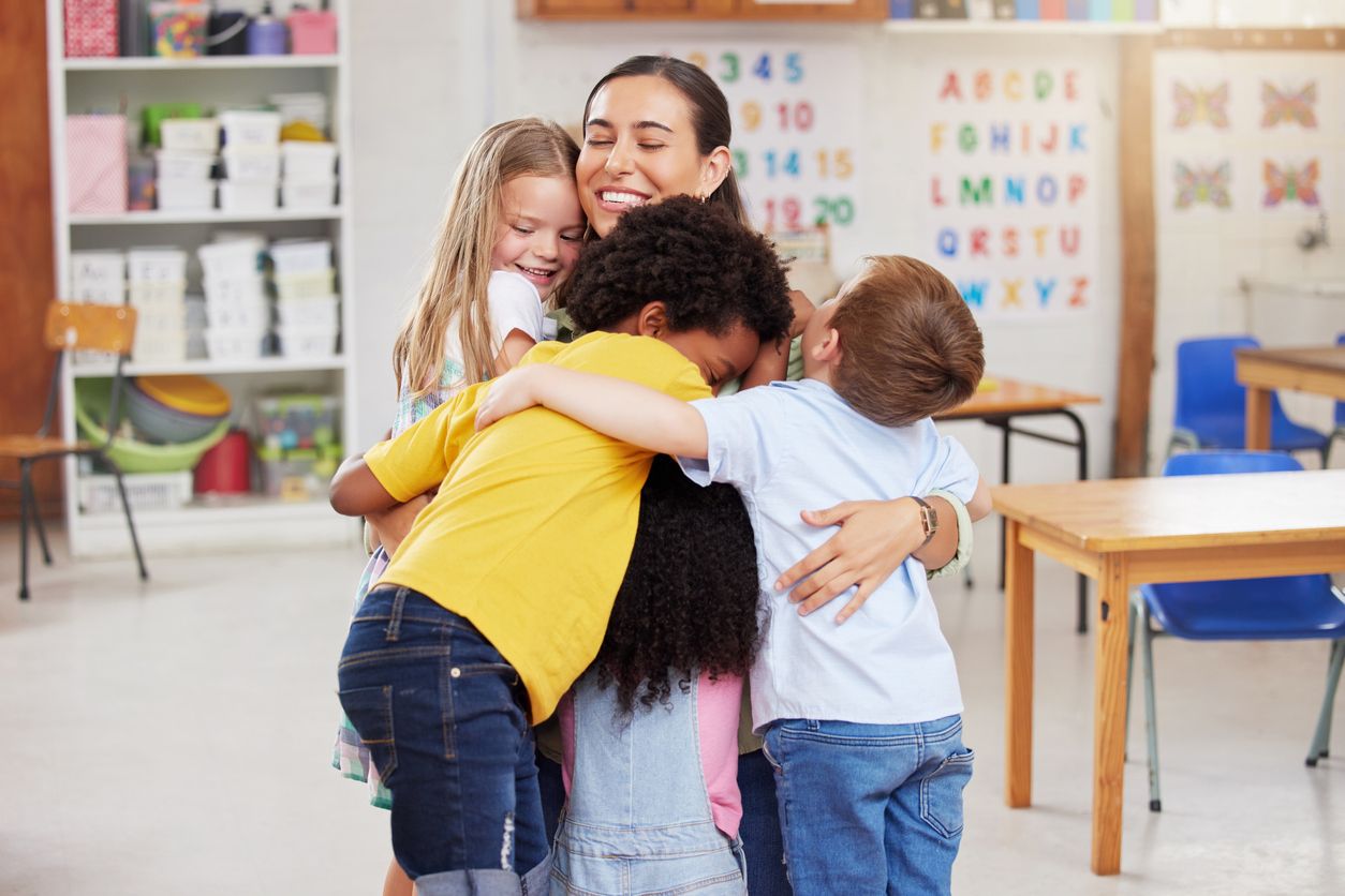 adult hugging students